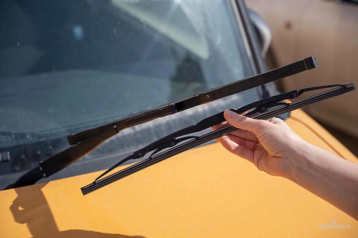 Covered frame winter wiper next to a flat beam wiper blade for comparison